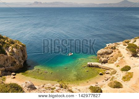 Aerial view of perachora's Ireon lake in Greece. Beautiful crystal clear sea with a boat in it.