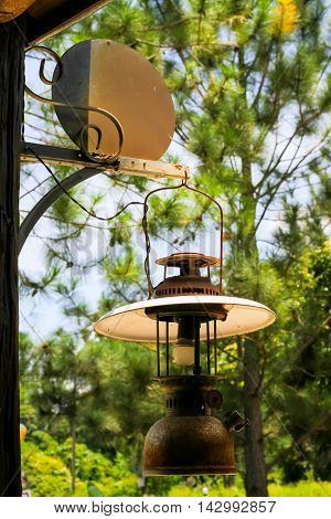 Old lantern hang on wood in the garden