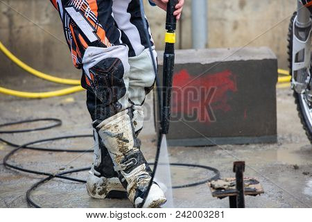 Biker A Man Cleaning Motorcycle From A High Pressure Washer
