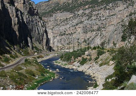 Mountain Range And River - Mountains Peaks And Railroad Tracks Along The Wind River Scenic Byway In 