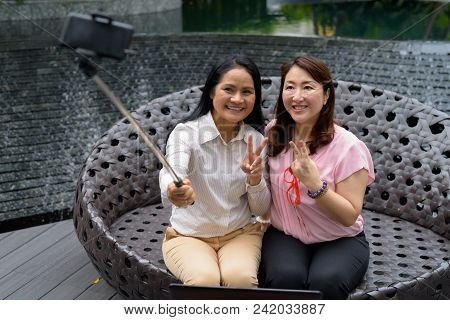 Portrait Of Two Mature Asian Women Together Outside The Mall In Bangkok City