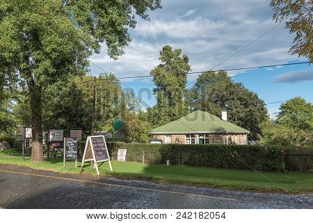 Himeville, South Africa - March 25, 2018: A Street Scene With A Restaurant And Road Stall In Himevil