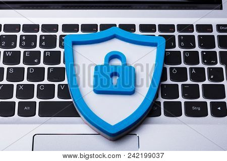 High Angle View Of A Blue Shield Security Sign On Laptop Keypad