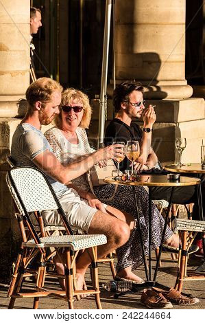 Paris, France - June 25, 2017: Parisians And Tourists Sit On The Terrace Of Le Nemours Cafe In The S