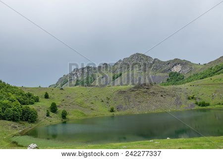 Rain Clouds Are Approaching The Mountain Lake.