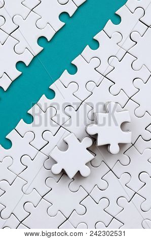 The Blue Path Is Laid On The Platform Of A White Folded Jigsaw Puzzle. The Missing Elements Of The P