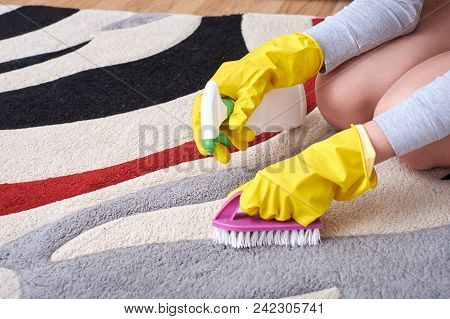 A Picture Of Women Hands In Yellow Gloves Cleaning The Floor.