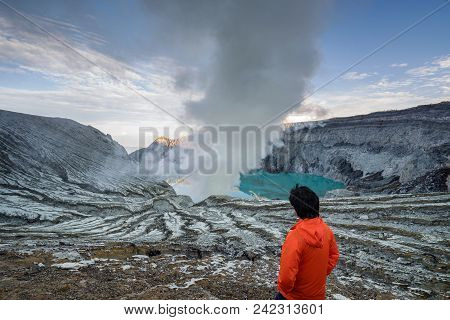 Young Travler Looking At Sulfur Burned By Blue Flame In The Crater Blue Lake At Kawah Ijen, Indonesi