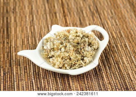 Dried Mullein Leaf Tea On A Wood Background