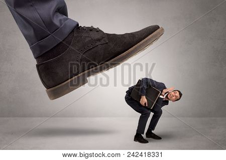 Young businessman illustrated inconsiderable by being trampled