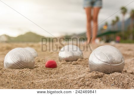 Beach. A Game Of Bocha. Brilliant Silver Balls For A Bocha On The Sand.