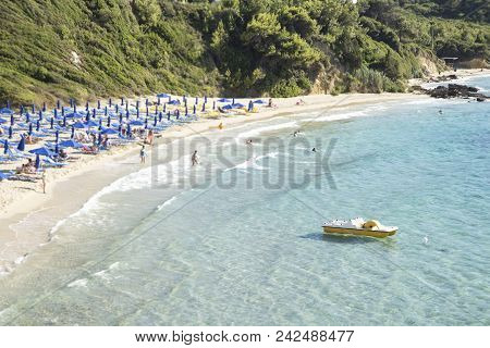 Beach With The Clear Turquoise Sea And A Yellow Boat