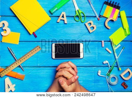 The Student Crossed His Hands In Front Of A Mobile Phone In The Workplace. A Place For Text. A Stude