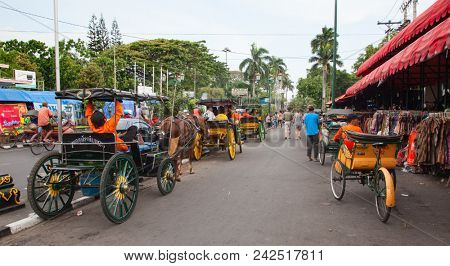 YOGYAKARTA - AUGUST 03: Traditional rikshaw transport on streets of Yogyakarta, Java, Indonesia on August 03, 2010. Bicycle rikshaw remains popular means of transport in many Indonesian cities.
