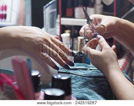 Close Up Paintig And Decorating Blue Color On Woman Nails At Salon In Night Market, Bangkok, Thailan