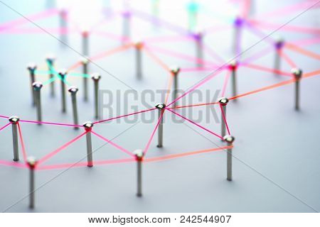 Linking entities. Networking, social media, SNS, internet communication abstract. devices or people connected to a network. Colorful Web of red, pink, orangeand green wires on white background.