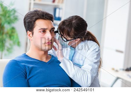 Doctor checking patients ear during medical examination