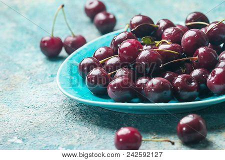 Fresh Cherry On Plate On Blue Background. Ripe Cherries. Sweet Berries.