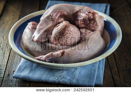 Raw Pork Tongues On A Vintage Bowl
