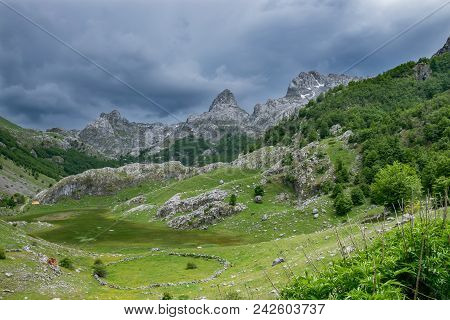 Rain Clouds Are Pushed On The Dried Up Mountain Lake.