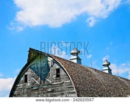 Roof And Cupolas Of An Old Abandoned Barn On An Empty Farm In Northern Minnesota.