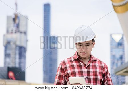 Asian Business And Engineer Man With Red Scott Shirt Has Planning And Working For Design Buiding And