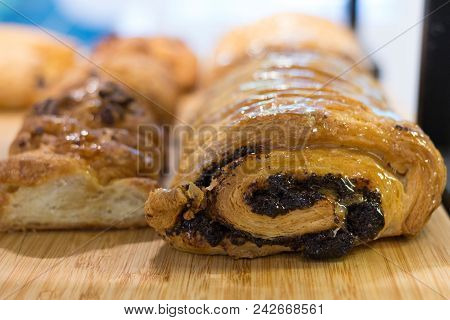 Splendid Original Homemade Swiss Roll With Poppy Seeds On The Wooden Plate With Shining Sugar Jam. D