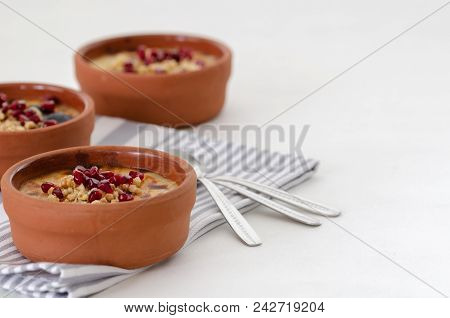 Traditional Turkish Oven Rice Pudding And Striped Napkin On White Backround.there Are Walnuts And Po
