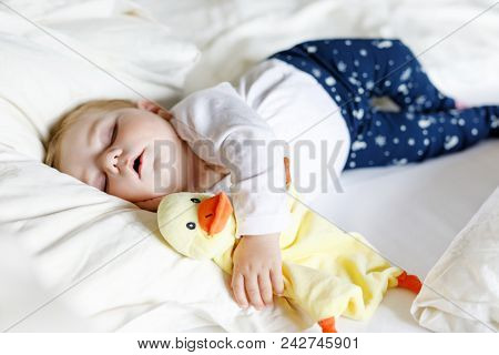 Cute Adorable Baby Girl Of 6 Months Sleeping Peaceful In Bed At Home. Closeup Of Beautiful Calm Chil