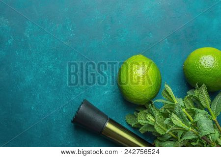 Ripe Organic Limes Fresh Spearmint Muddler On Dark Blue Background. Mojito Cocktail Ingredients. Vib