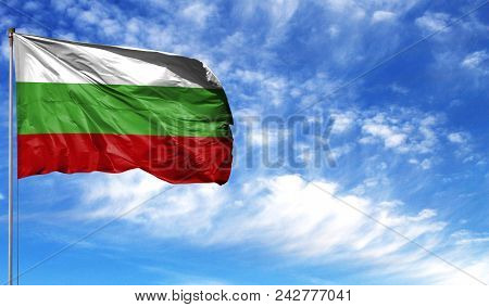 Flag Of Bulgaria On Flagpole Against The Blue Sky.