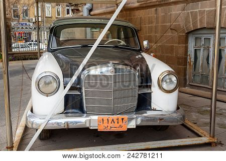 Tabriz, East Azerbaijan Province, Iran - March 15, 2018: Old Mercedes Benz Taxi Car Near Saat Tower,