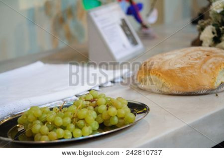 Bunches Of Grapes On A Table Near A Bread. Church Of Girone, Tuscany Italy