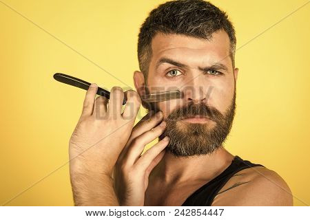 Man Face Handsome. Serious Hipster In Barbershop, New Technology. Man Cut Beard And Mustache With Ra