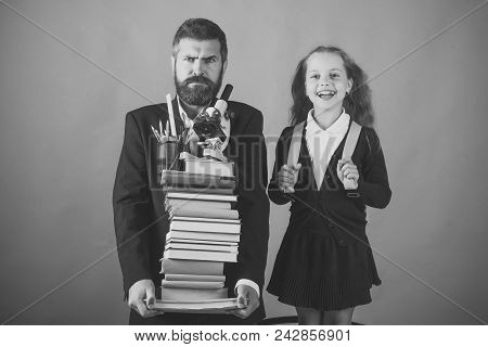 Father And Schoolgirl With Mad And Happy Faces On Green Background. Home Schooling And Back To Schoo