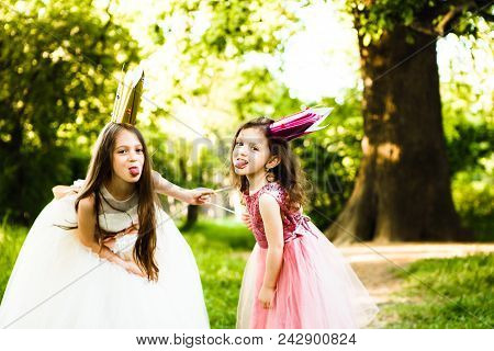 Lovely Sisters Made Of Cardboard Crowns And Play Princesses.