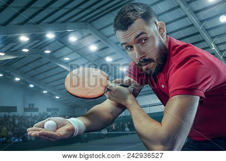 The Table Tennis Player In Motion. Fit Young Sports Man Tennis-player In Play On Sport Arena Backgro