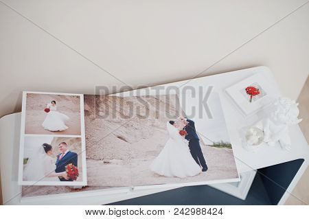 Pages Of Elegant Photobook Or Wedding Album On A Small Table.
