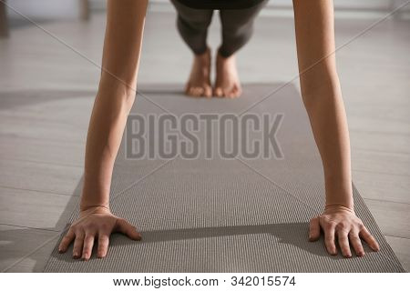 Young Woman Practicing Plank Asana In Yoga Studio, Closeup. Phalankasana Pose