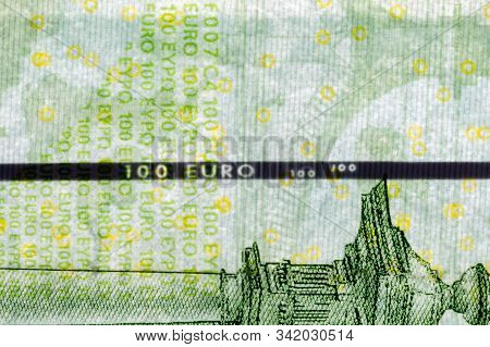Close-up On Plastic Security Strip Inside 100 Euro Banknote.