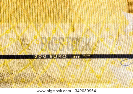 Close-up On Vertically Plastic Security Strip Inside 200 Euro Banknote.