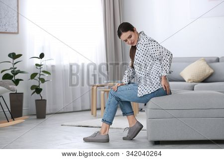 Young Woman Suffering From Hemorrhoid At Home