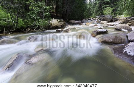 Colorado Flowing Creek High In The Rocky Mountains.