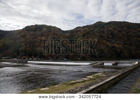 Kyoto, Japan-26 Nov, 2019: Katsuragawa River With Colourful Forest Mountain Background In Arashiyama