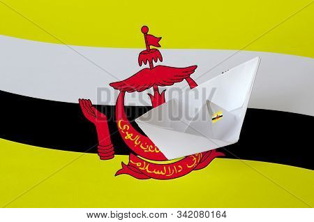 Brunei Darussalam Flag Depicted On Paper Origami Ship Closeup. Handmade Arts Concept