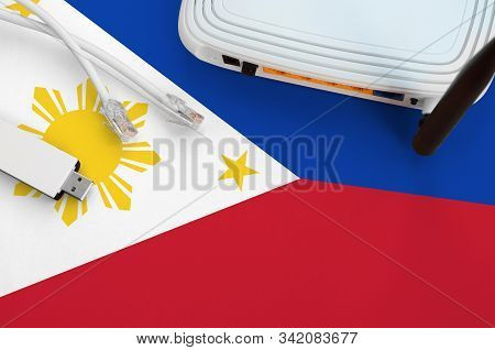 Philippines Flag Depicted On Table With Internet Rj45 Cable, Wireless Usb Wifi Adapter And Router. I