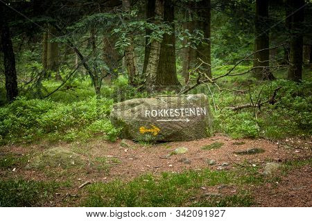 Bornholm, Denmark - June 2018. A Large Stone Used As A Guide, To The Popular Attraction 