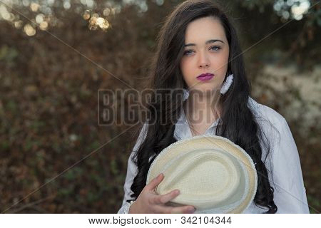 Portrait Of Young Woman With A Hat.