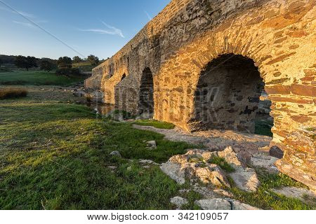 Ancient Roman Bridge Over The Salor River, Located Near Aliseda. Extremadura. Spain.