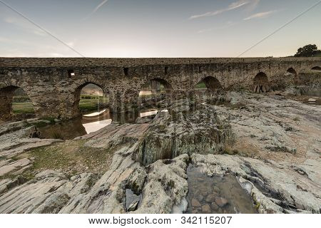 Ancient Roman Bridge Over The Salor River, Located Near Aliseda. Extremadura. Spain.